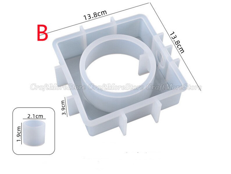 May include: White silicone mold for making candles. The mold is square with a round opening in the center. The mold measures 13.8 cm by 13.8 cm by 3.9 cm. A smaller silicone mold for making candles is also shown, measuring 1.9 cm in diameter and 2.1 cm in height.