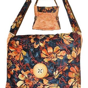 May include: A shoulder bag featuring a dark blue and orange floral pattern with a large round wooden button closure on the front flap. The bag includes a long shoulder strap and a smaller pouch labeled Back, with the main bag labeled Front of Bag.