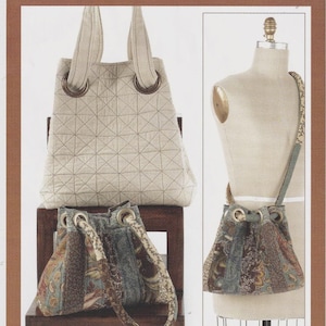 May include: A sewing pattern cover titled Indygo Junction Grids & Grommets IJ805 featuring two tote bags. One bag is a light beige quilted fabric with large grommets, and the other is a multi-colored floral and paisley print fabric with grommets.