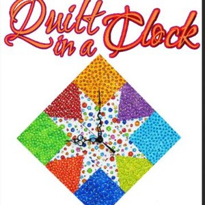 May include: A colorful quilt clock with a white background and a black clock face. The quilt is made of different colored fabrics with a pattern of small dots. The clock hands are black.