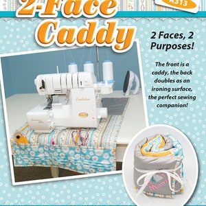 May include: A sewing caddy with the text "2-Face Caddy" and "2 Faces, 2 Purposes!". The caddy has a blue and white patterned fabric. The front is a caddy, and the back doubles as an ironing surface. A sewing machine and iron are visible.