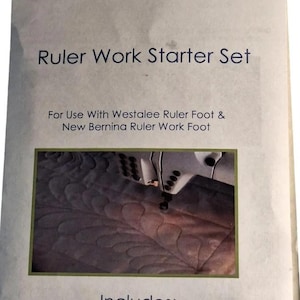 May include: A Westalee Design by Sew Steady Ruler Work Starter Set product package. The white packaging features black text, including 'Ruler Work Starter Set', 'For Use With Westalee Ruler Foot & New Bernina Ruler Work Foot', and 'Includes: 12" Arc Template, 3" Feather Template & Stable Tape'.