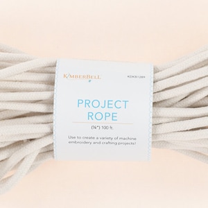 May include: A white cotton rope, 100 feet long, labeled "Project Rope" by the brand "Kemberdell".