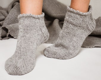 Knitted gray frilly ruffle top wool ankle socks for women in custom sizes and colors. Handmade home slipper socks for bed, lounging, sleep