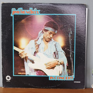 May include: A black vinyl record album cover featuring Jimi Hendrix playing a white electric guitar. The album title is "In Concert" and the record label is "Reprise Records".