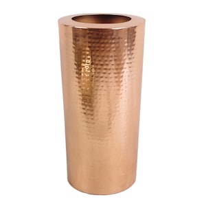 May include: A copper-coloured, cylindrical vase with a hammered texture. The vase has a wide opening at the top and a smooth, polished interior. The exterior has a dimpled pattern, adding visual interest to the decorative piece.
