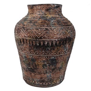 May include: A large, brown ceramic vase with a geometric pattern. The vase has a distressed finish and a wide mouth.