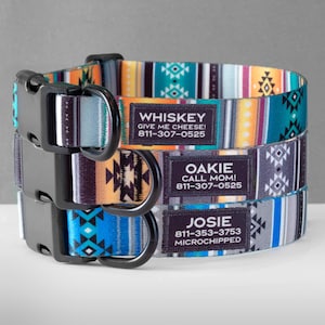 May include: Three colorful dog collars with black buckles and personalized name tags. The top collar is turquoise, orange, and white with the name "WHISKEY" and the text "GIVE ME CHEESE! 811-307-0525". The middle collar is gray, orange, and black with the name "OAKIE" and the text "CALL MOM! 811-307-0525". The bottom collar is blue, gray, and white with the name "JOSIE" and the text "811-353-3753 MICROCHIPPED".