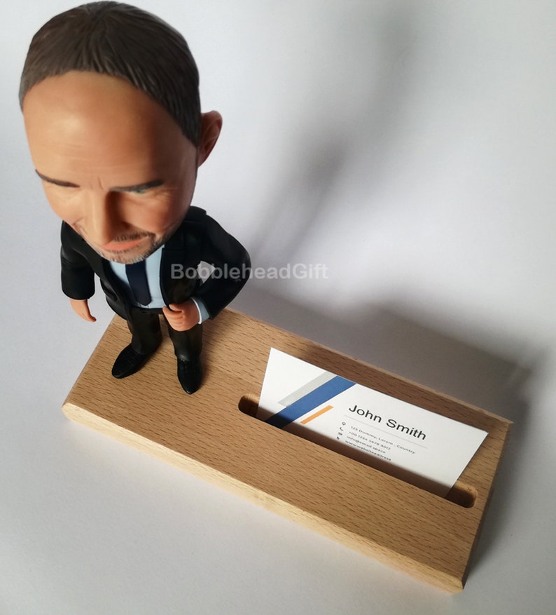 Lawyer bobblehead from above with business card in card holder.