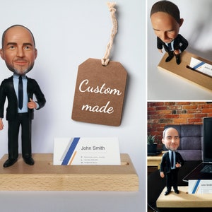Lawyer business card holder made from birch wood with male attorney figurine in business suite. Base has hole with business cards inside. Second picture in office with laptop behind.