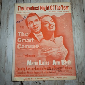 May include: A vintage sheet music cover for the song "The Loveliest Night of the Year" from the film "The Great Caruso". The cover features a colour photo of Mario Lanza and Ann Blyth, the stars of the film.