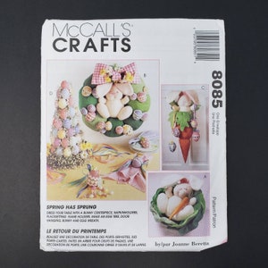 May include: A sewing pattern for Easter crafts. The pattern includes instructions for making a bunny centrepiece, napkin holders, place setting name holders, an egg tree, a door hanging, a bunny and egg wreath. The pattern is by Joanne Beretta.