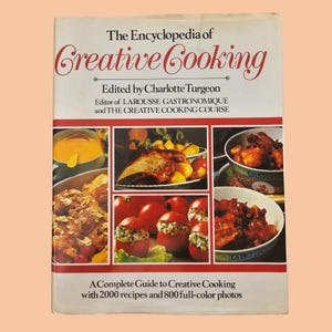 May include: A vintage cookbook titled "The Encyclopedia of Creative Cooking" with a white cover and red text. The cover features food photography of various dishes. The book is edited by Charlotte Turgeon and includes 2000 recipes and 800 full-colour photos.