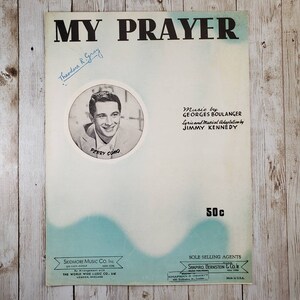 May include: A vintage sheet music cover for the song "My Prayer" by Perry Como. The cover features a black and white photo of Perry Como and the song title in large, bold letters. The sheet music is priced at 50 cents.