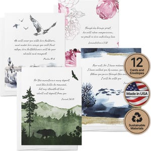 May include: Set of 12 cards and envelopes with watercolor designs and inspirational quotes. The cards feature images of birds, mountains, and floral elements. Includes a "Made in USA" label and a "Sustainable Materials" label.