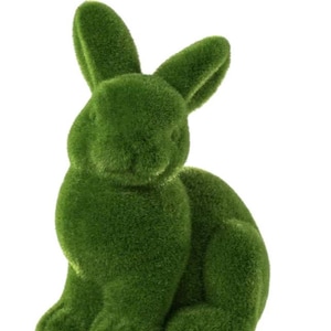 May include: A green, moss-covered rabbit figurine. The bunny is in a seated position with its ears perked up. The artificial grass texture gives the rabbit a soft, natural appearance. Perfect for Easter or spring decor.