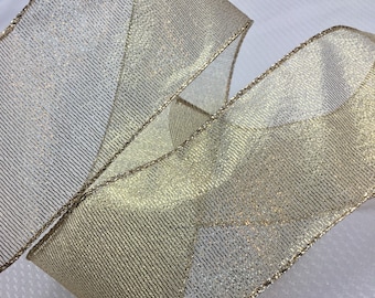 May include: Gold and silver metallic ribbon with a shimmery finish. The ribbon has a woven texture and is ideal for adding a touch of sparkle to any craft project.