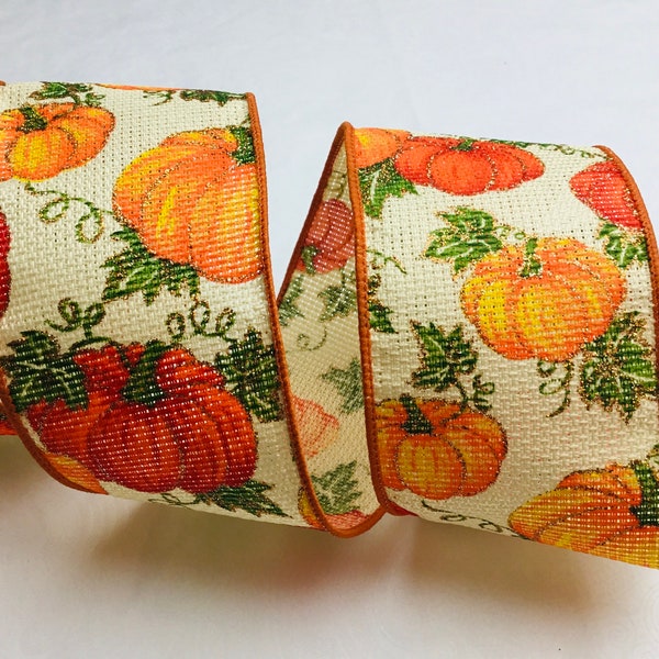 Pumpkins and leaves on faux burlap