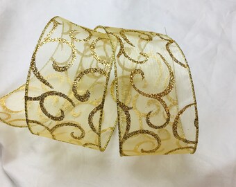 May include: A roll of sheer gold ribbon with a glittery swirl pattern.
