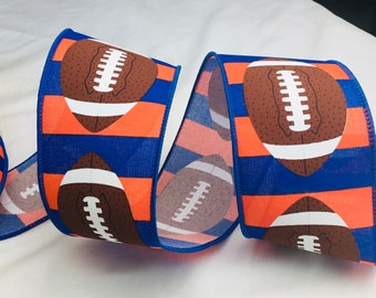 May include: Blue and orange striped ribbon with a white football design. The football is brown with white laces.