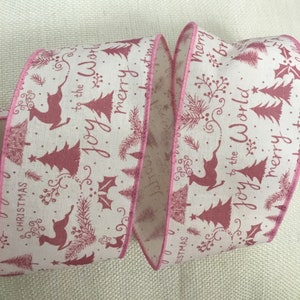 May include: Pink and white ribbon with a repeating pattern of pink Christmas trees, reindeer, and the text "Joy to the World" and "Merry Christmas".