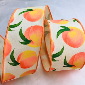 May include: Peach-themed ribbon with a white background and orange trim. The ribbon features a repeating pattern of peaches with green leaves.