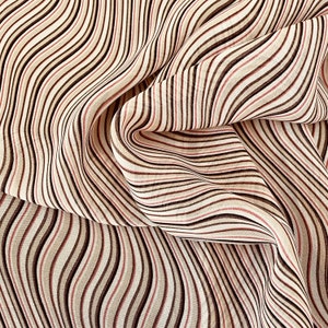 Wavy Stripe Printed viscose in orange, tan, ecru and black. Drapey. lightweight, sheer. Origin: Germany