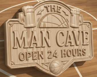 May include: Wooden sign carved with the words "THE MAN CAVE OPEN 24 HOURS." The sign features a basketball, two beer mugs, and a basketball court background. The sign is made of light-colored wood.
