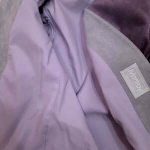 May include: A purple and gray suede jacket with a lavender lining. The jacket has a label that says "Montroy" on the inside.