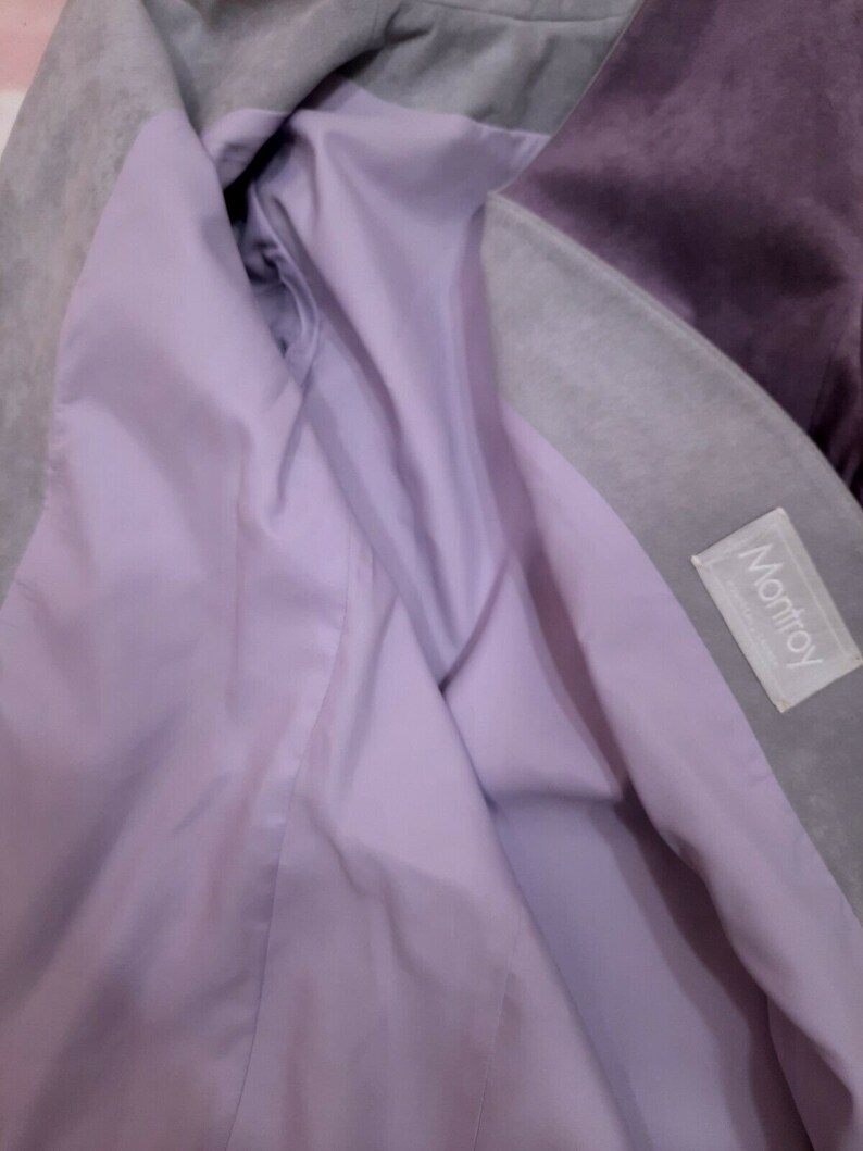 May include: A purple and gray suede jacket with a lavender lining. The jacket has a label that says "Montroy" on the inside.