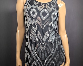 May include: Black tank top with silver sequin and bead embellishments in a geometric pattern. The sleeveless top features a scoop neckline and a slightly curved hemline. The design is reminiscent of Art Deco styles.