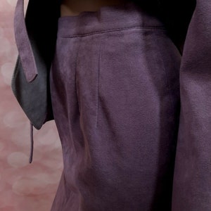 May include: A purple suede skirt with a high waist and a straight silhouette.