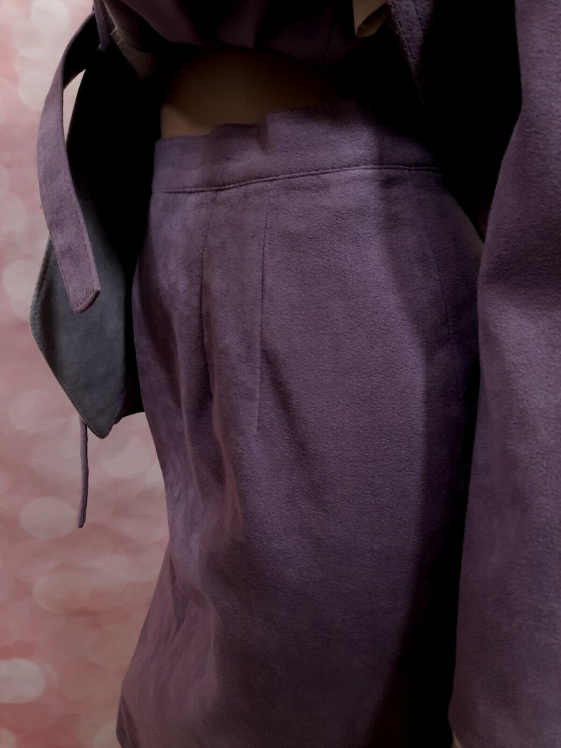 May include: A purple suede skirt with a high waist and a straight silhouette.