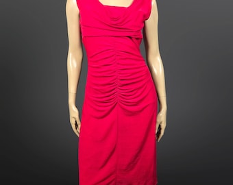 May include: A vibrant red dress with a draped neckline and a fitted silhouette. The sleeveless dress features ruching down the front, adding texture and detail. The dress falls to the knee, offering a classic and elegant look.