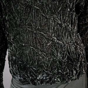May include: Black velvet top with a textured, crinkled design. The fabric has a raised, almost quilted look.
