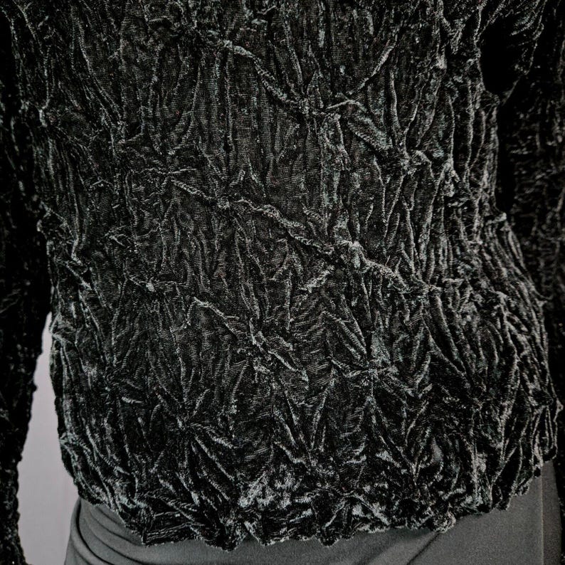 May include: Black velvet top with a textured, crinkled design. The fabric has a raised, almost quilted look.