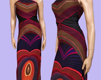 May include: A strapless, floor-length dress with a striking geometric design. The dress has a black bodice and a skirt with concentric circles and chevron stripes in red, orange, purple, and yellow. The dress is displayed on a mannequin.