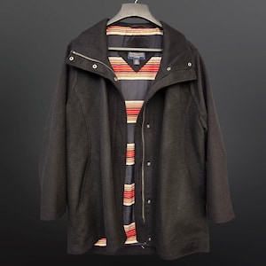 May include: A black wool coat with a zip and button fastening. The coat has a high collar and a striped lining.