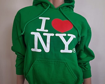 May include: Green hooded sweatshirt with a white "I love NY" graphic and a red heart.
