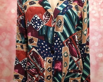 May include: A colorful, abstract patterned blazer with a button closure. The blazer features a mix of geometric shapes, stripes, and polka dots in shades of red, blue, green, brown, and white.