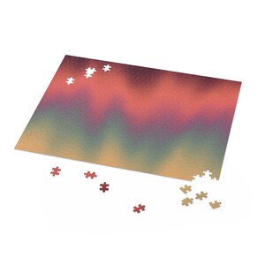 May include: A partially completed jigsaw puzzle with a gradient of colors from yellow to green to red. The puzzle pieces are scattered around the main puzzle board.