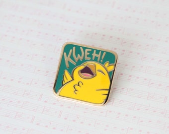 May include: A green and yellow enamel pin featuring a cartoon yellow bird with its mouth open, singing "KWEH!" The pin is on a white background with musical notes.