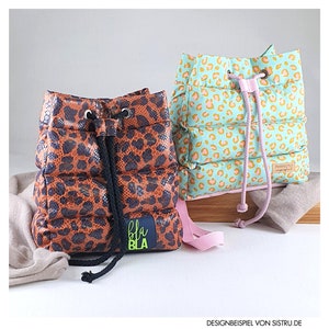 May include: Two drawstring backpacks. One is brown with a leopard print and a black drawstring. The other is mint green with a leopard print and a pink drawstring. The brown bag has a blue patch with the text "bla bla".