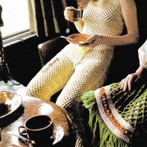 May include: A woman wearing a crocheted jumpsuit with a fringe trim. She is sitting at a table with a cup of coffee and a plate. The text "Twine Ware" is visible on the table.