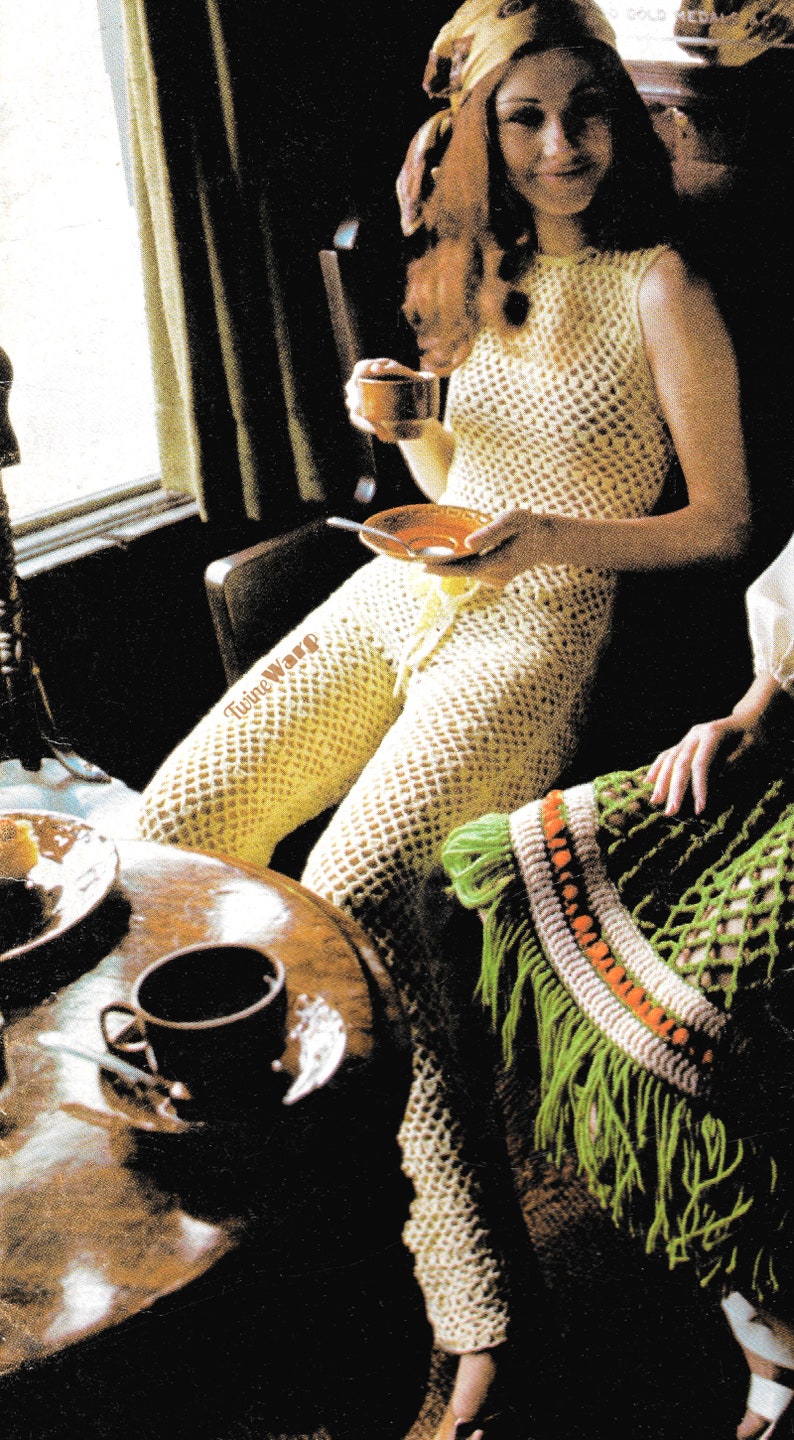 May include: A woman wearing a crocheted jumpsuit with a fringe trim. She is sitting at a table with a cup of coffee and a plate. The text "Twine Ware" is visible on the table.