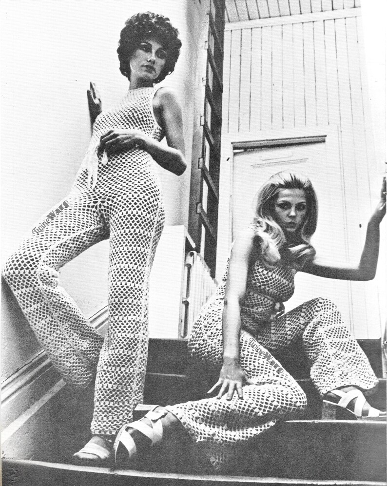 May include: Two women wearing matching crochet jumpsuits with a geometric pattern. The jumpsuits have wide legs and are sleeveless. The women are posing on a staircase.