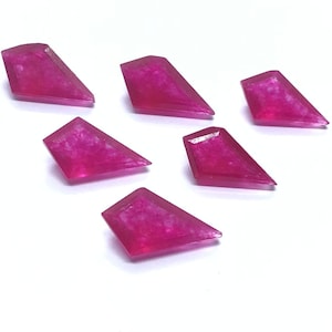 May include: Six pink diamond-shaped resin pieces with a sparkly finish.