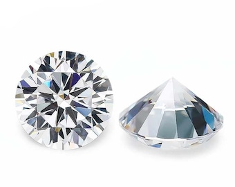 May include: Two clear, round-cut gemstones are displayed against a white background. The gemstones are faceted, with multiple reflective surfaces. One stone is viewed from the top, and the other is viewed from the side, showcasing their brilliance.