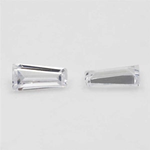 May include: Two clear, rectangular, faceted gemstones on a white background.