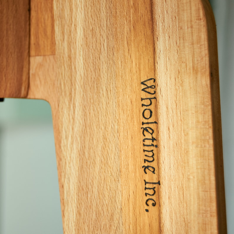 May include: A close-up of a wooden cutting board with the text "Wholetime Inc." engraved on the side.